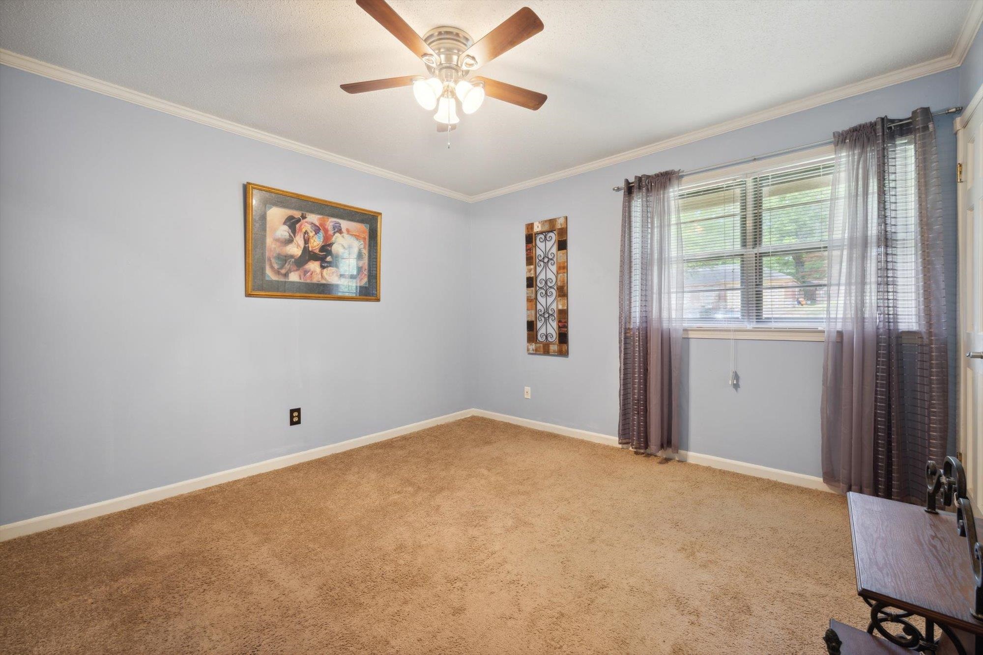 2936 Falkirk Road Memphis, TN 38128 - Photo 8 of 25 an empty room with windows and fan