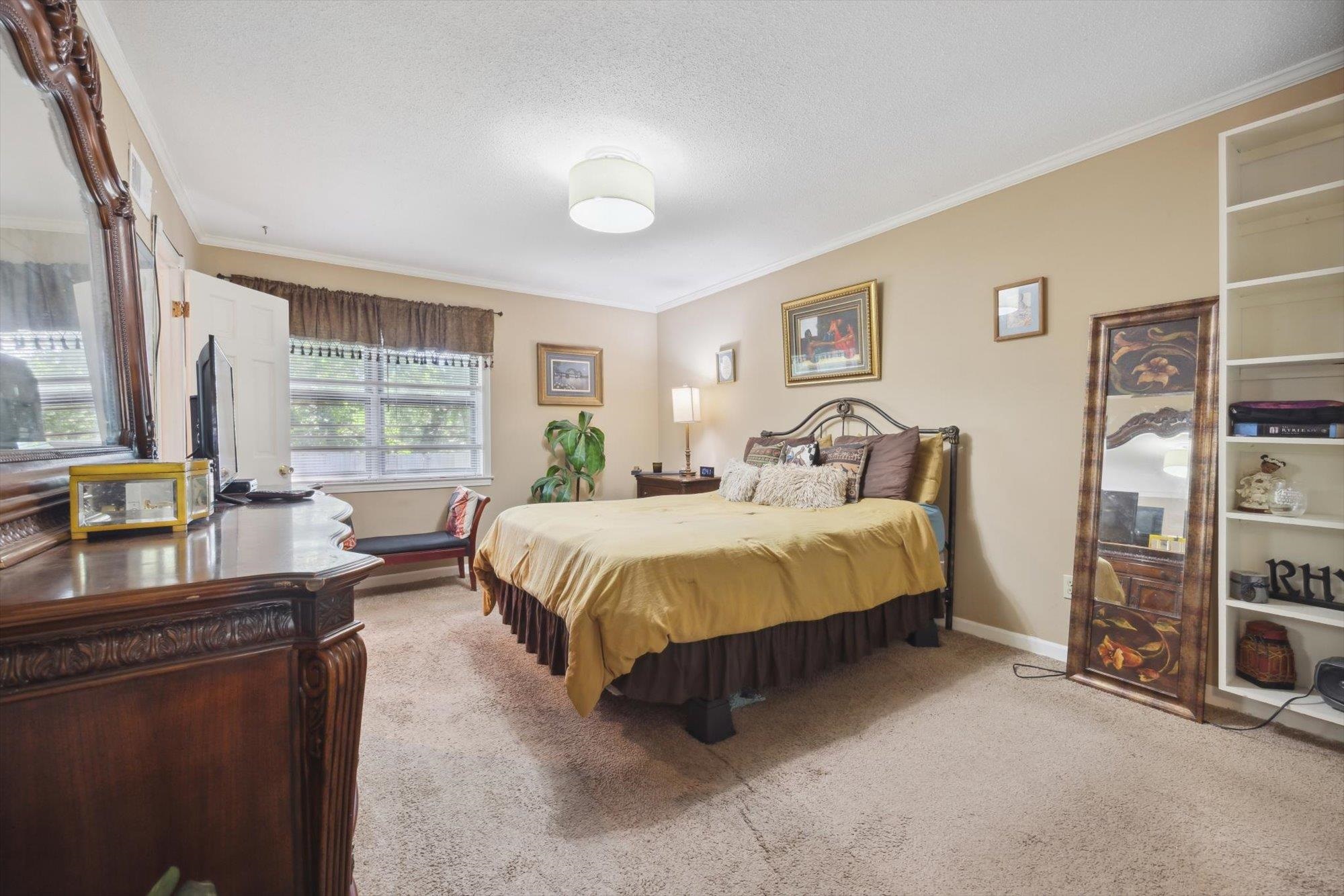 2936 Falkirk Road Memphis, TN 38128 - Photo 9 of 25 a spacious bedroom with a bed a table and large window