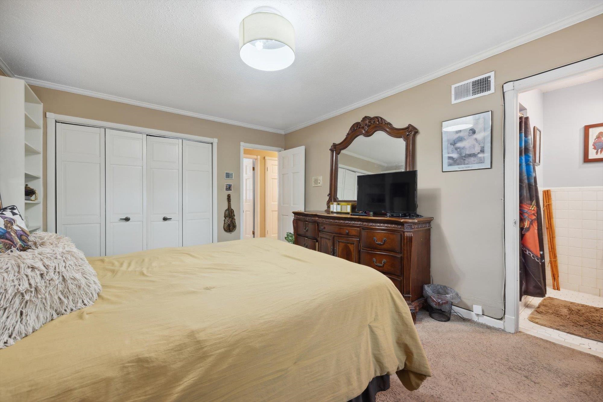 2936 Falkirk Road Memphis, TN 38128 - Photo 10 of 25 a bedroom with a bed and a flat screen tv