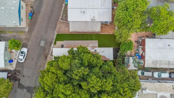 an aerial view of a house with outdoor space
