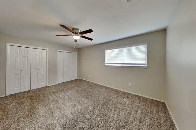 a view of a livingroom with a ceiling fan and window