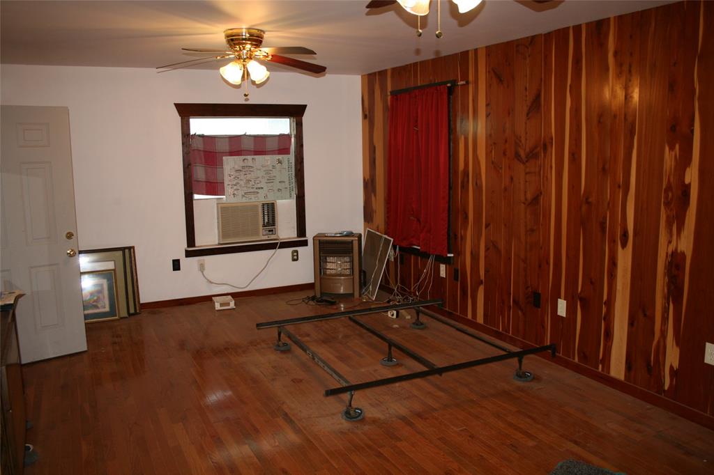 430 Rio Road Millsap, TX 76066 - Photo 4 of 25 wood floors, ceiling fan, and wood walls
