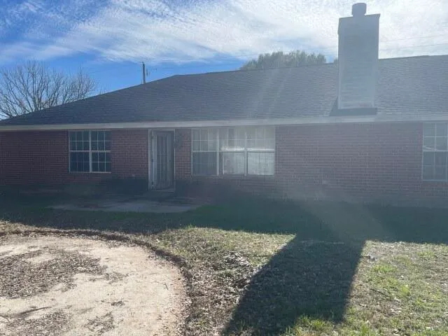 a bed sitting in a bedroom next to a large window