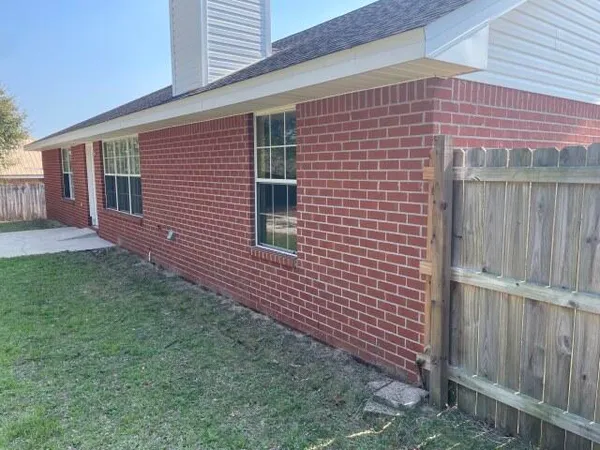 a brick building with a yard