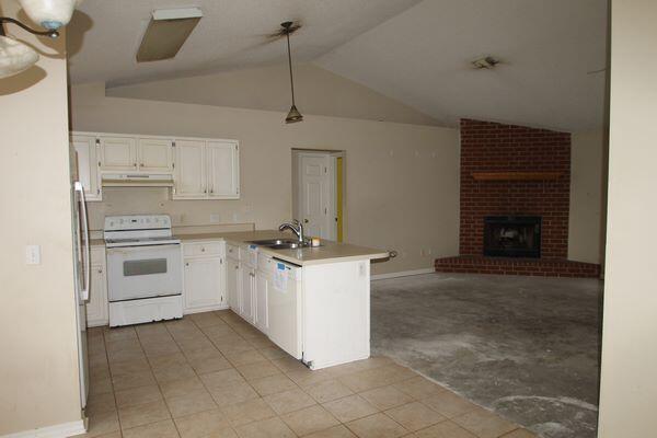 326 Riverchase Boulevard Crestview, FL 32536 - Photo 6 of 24 a kitchen with a stove sink and cabinets