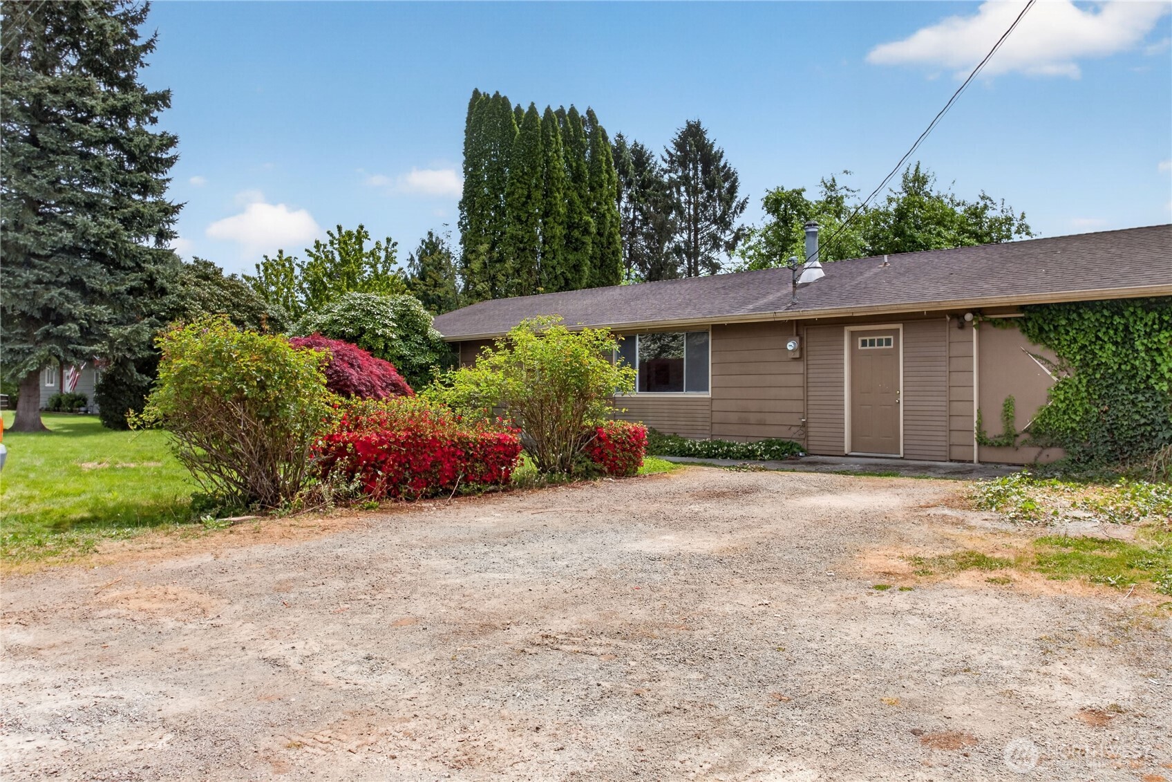 716 Murphy Way Sultan, WA 98294 - Photo 2 of 31 a view of a house with a small yard and a large parking space