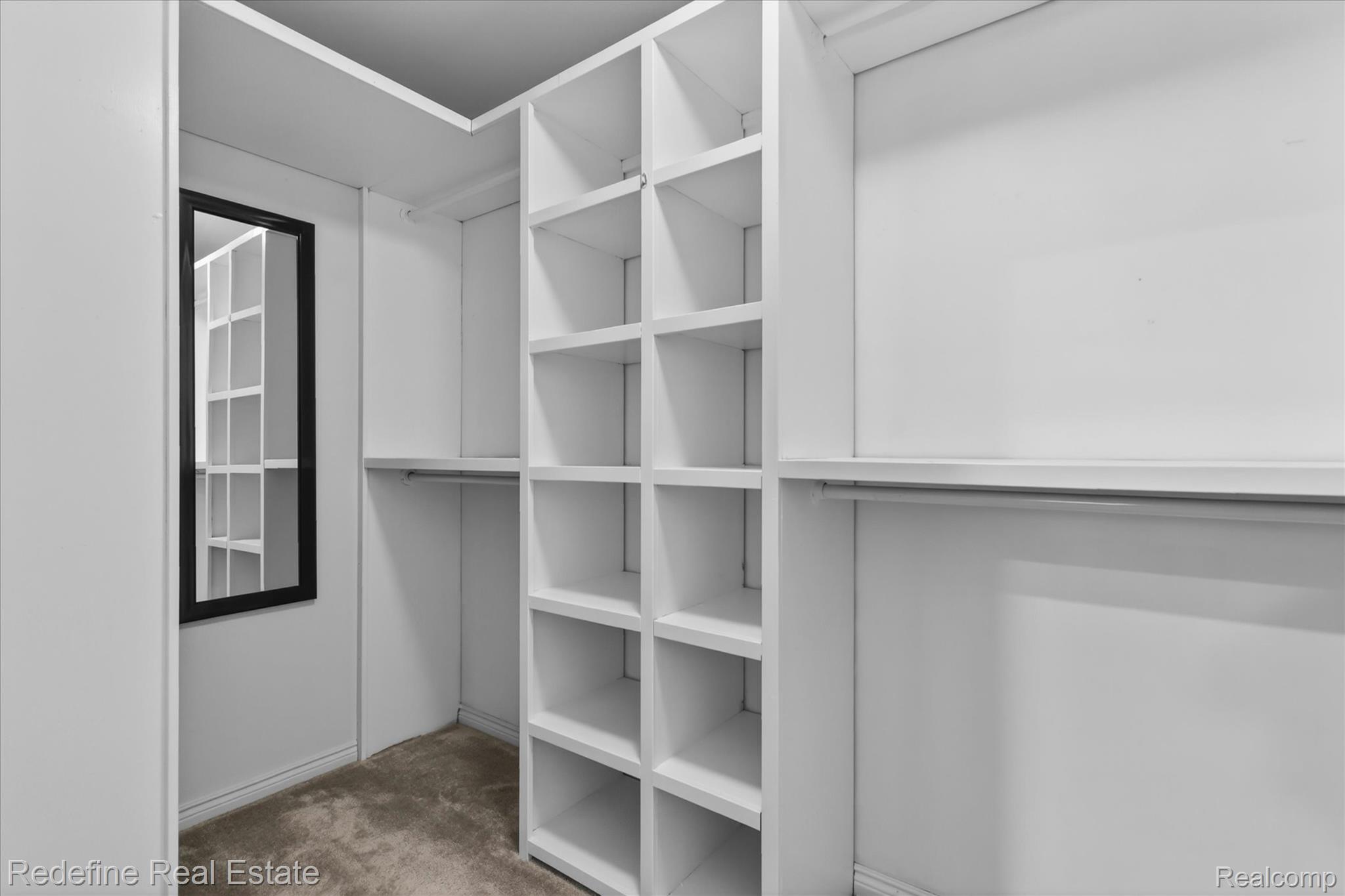 2976 Andlaur Drive Rochester, MI 48307 - Photo 29 of 60 Custom closet system featuring multiple shelves, hanging rods, and a full-length mirror