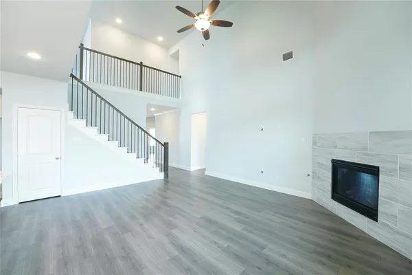 a view of entryway and kitchen with wooden floor