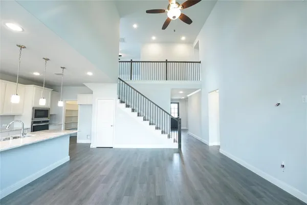 an empty room with a window and a ceiling fan