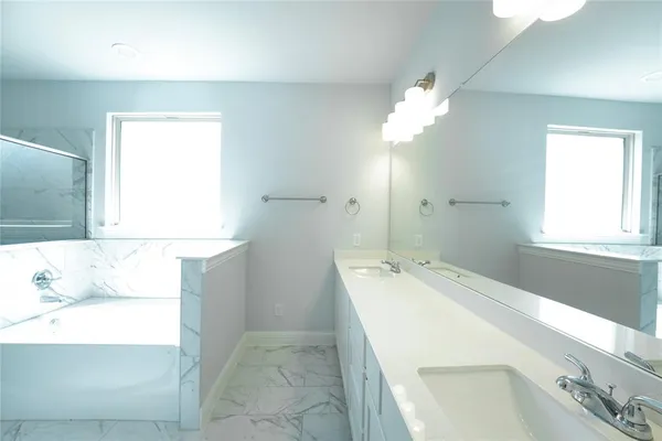 a bathroom with a bathtub and a shower