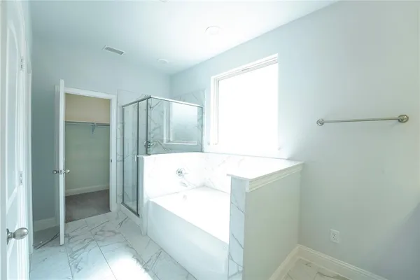 a bathroom with a bathtub sink and mirror