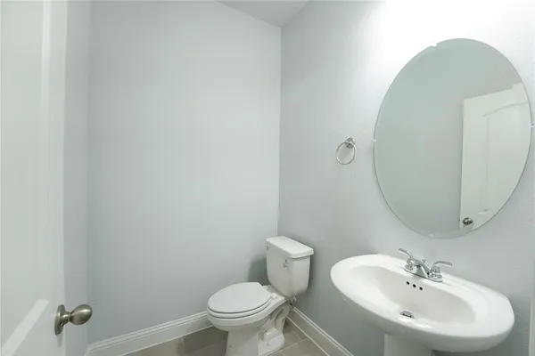 a bathroom with a sink mirror and toilet