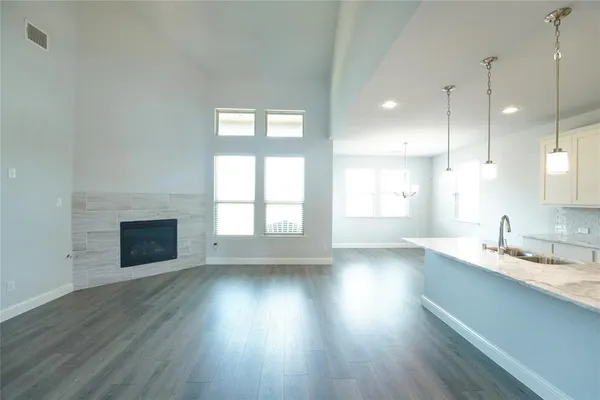 a view of kitchen with wooden floor and electronic appliances
