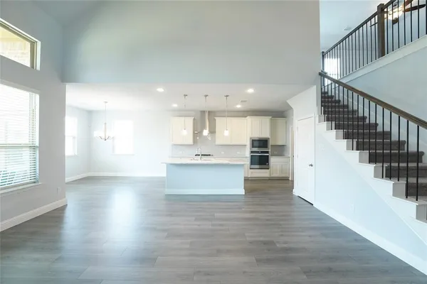 a large kitchen with kitchen island a sink stainless steel appliances and cabinets