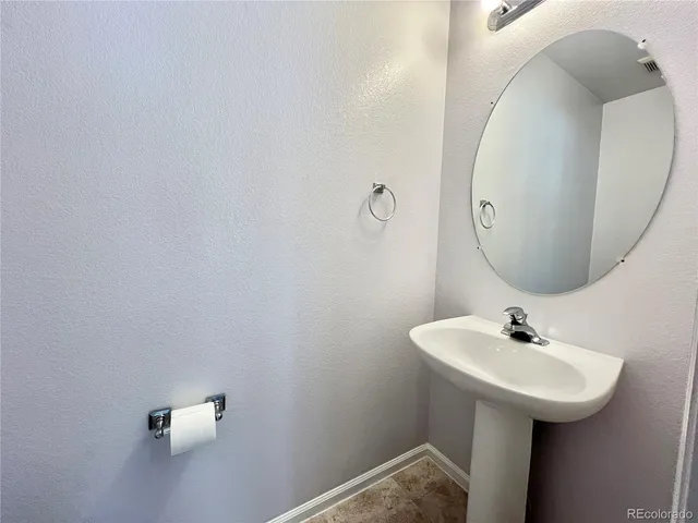 a bathroom with a sink and mirror