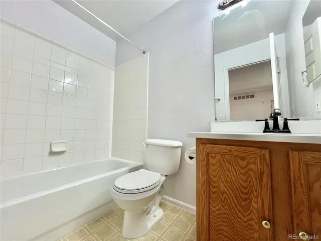 a bathroom with a toilet a sink and bathtub