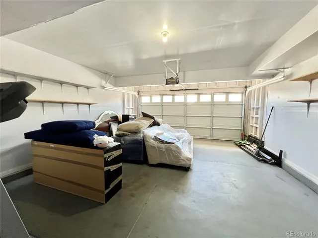 a living room with furniture a window and gym equipment
