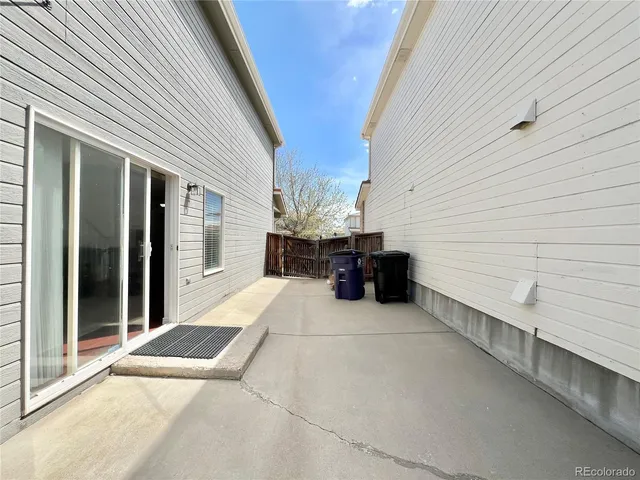 a view of a patio with table and chairs with wooden fence and roof