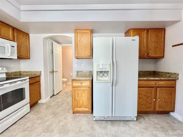 a kitchen with stainless steel appliances a refrigerator stove and sink