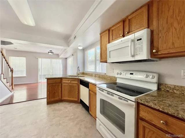 a kitchen with stainless steel appliances granite countertop a stove and a sink