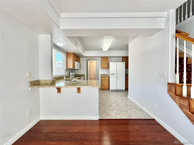 a view of kitchen with furniture and wooden floor