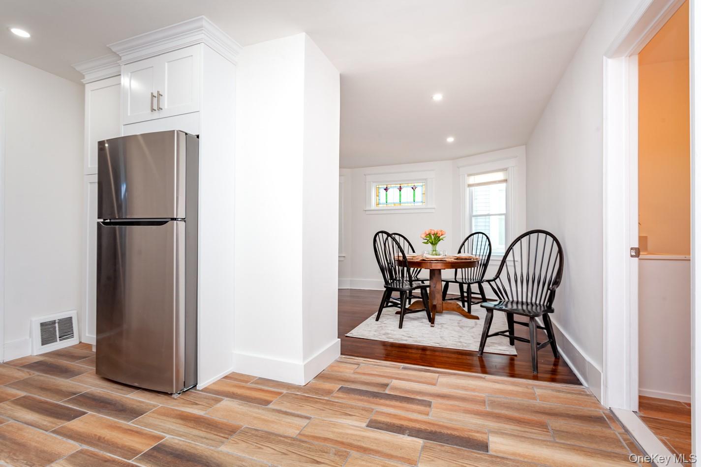 89 Smith Street Poughkeepsie, NY 12601 - Photo 11 of 42 a view of a kitchen with dining table and chairs