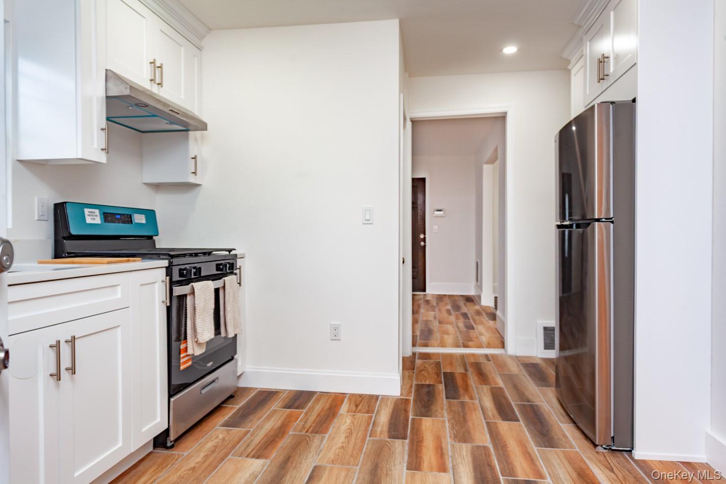 89 Smith Street Poughkeepsie, NY 12601 - Photo 12 of 42 a kitchen with stainless steel appliances granite countertop a refrigerator a stove and a sink