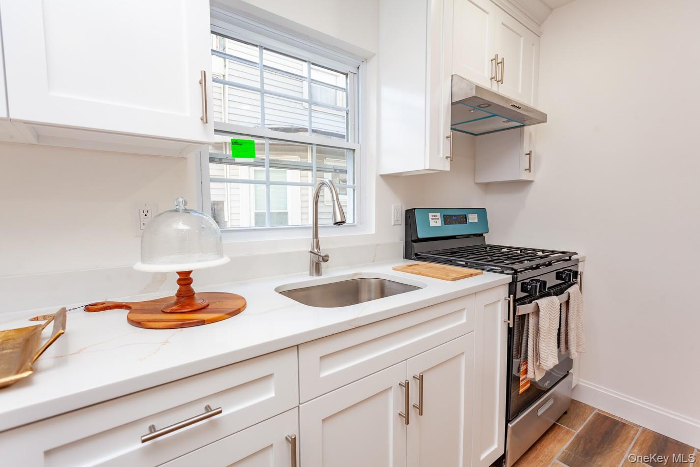 89 Smith Street Poughkeepsie, NY 12601 - Photo 16 of 42 a kitchen with stainless steel appliances a sink stove and window