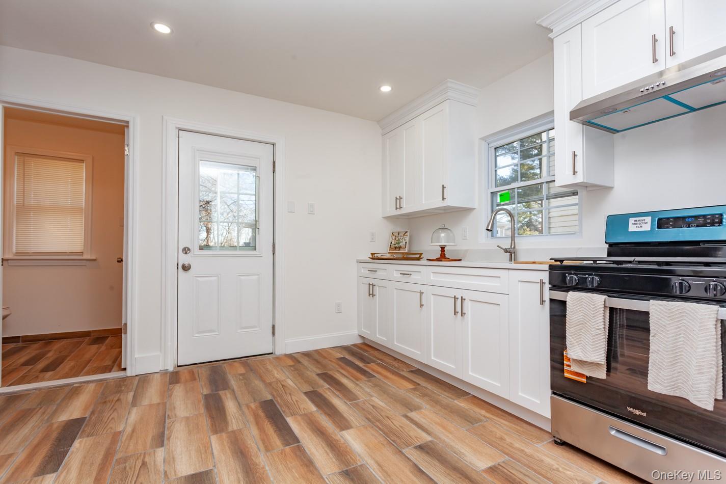 89 Smith Street Poughkeepsie, NY 12601 - Photo 17 of 42 a kitchen with granite countertop white cabinets and white appliances