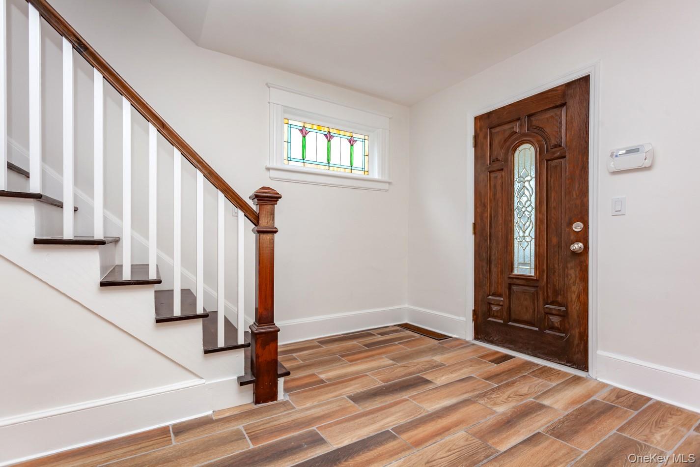 89 Smith Street Poughkeepsie, NY 12601 - Photo 19 of 42 a view of an entryway with wooden floor and stairs