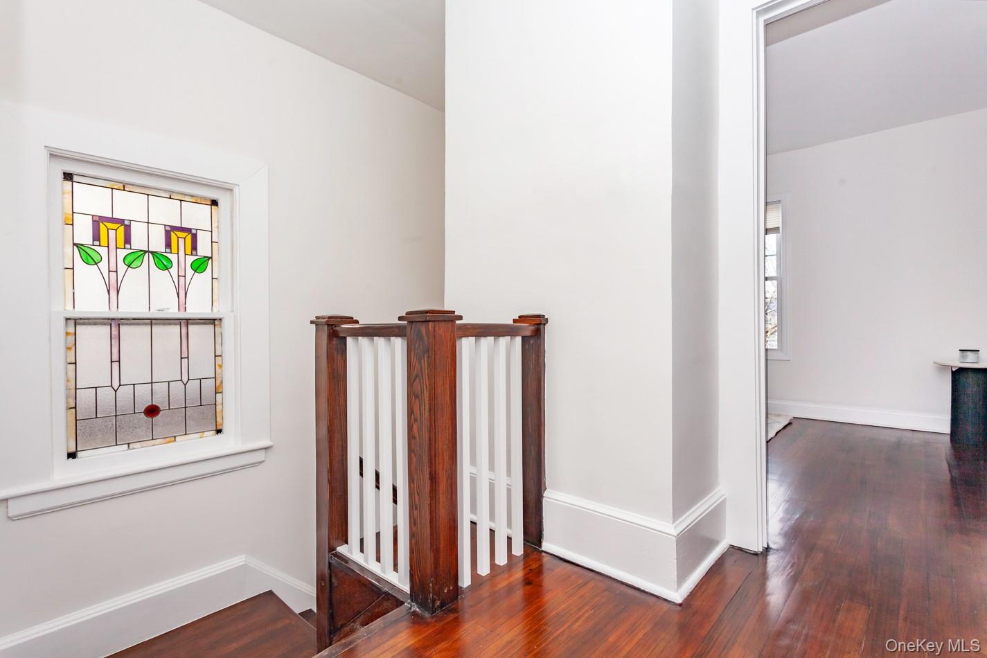 89 Smith Street Poughkeepsie, NY 12601 - Photo 20 of 42 an empty room with wooden floor and windows