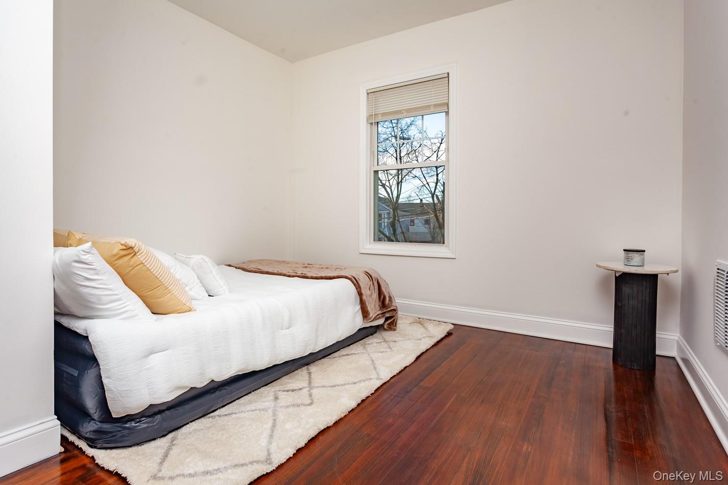 89 Smith Street Poughkeepsie, NY 12601 - Photo 21 of 42 a bedroom with a bed and wooden floor