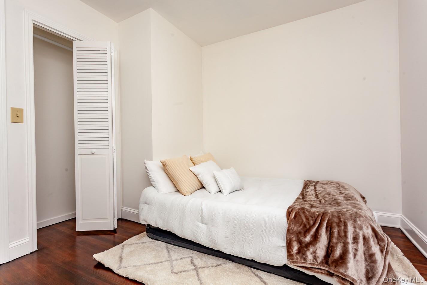 89 Smith Street Poughkeepsie, NY 12601 - Photo 22 of 42 a bedroom with a bed and wooden floor