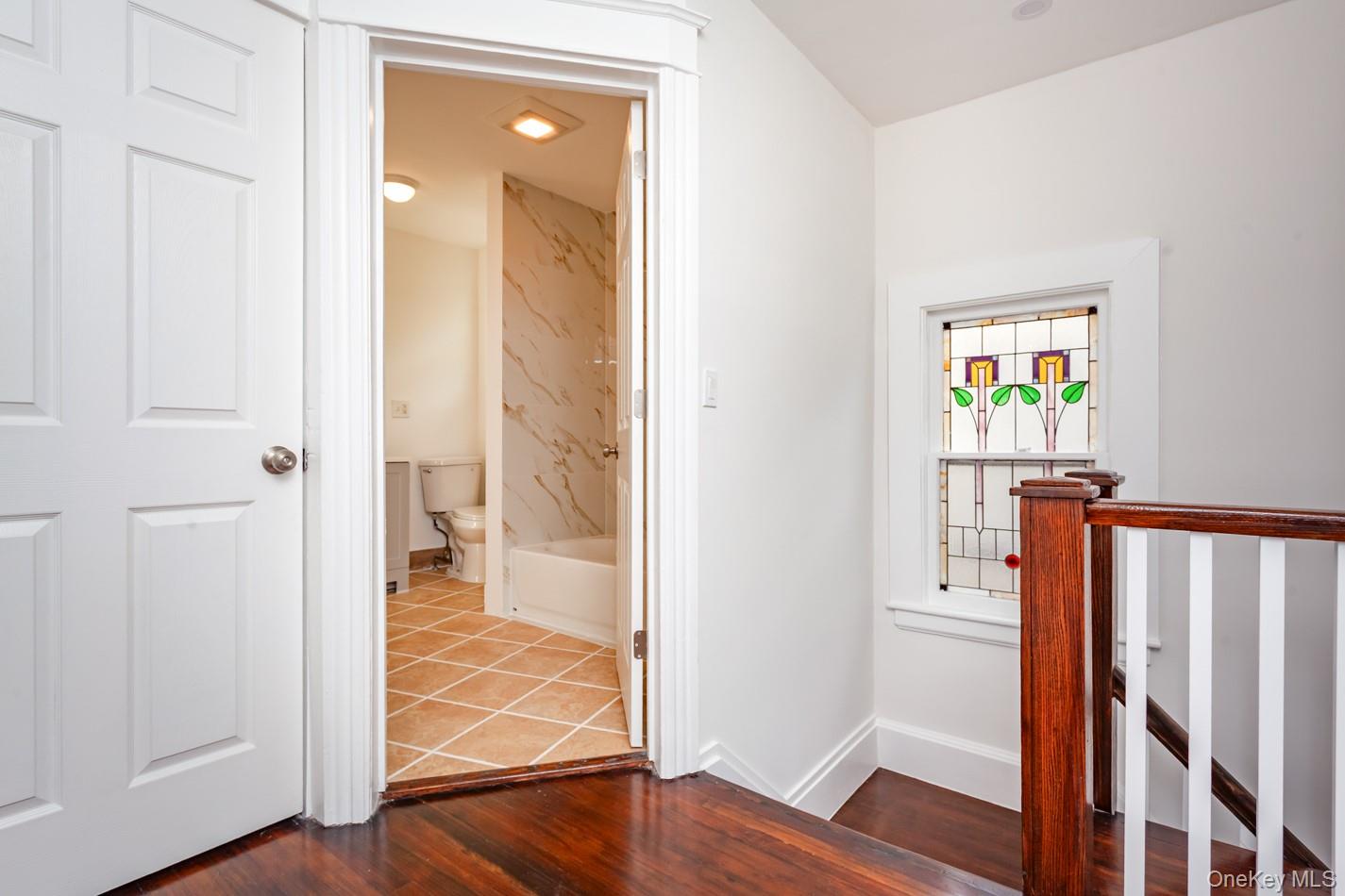 89 Smith Street Poughkeepsie, NY 12601 - Photo 25 of 42 a view of a hallway with wooden floor and closet area