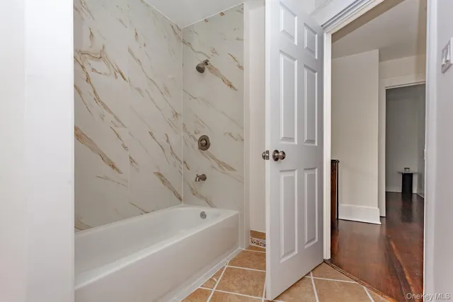 a bathroom with a bathtub and shower