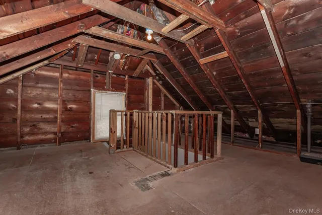 a view of an empty room with wooden walls