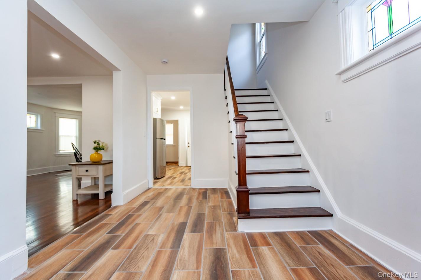 89 Smith Street Poughkeepsie, NY 12601 - Photo 6 of 42 a view of a bedroom with wooden floor and stairs