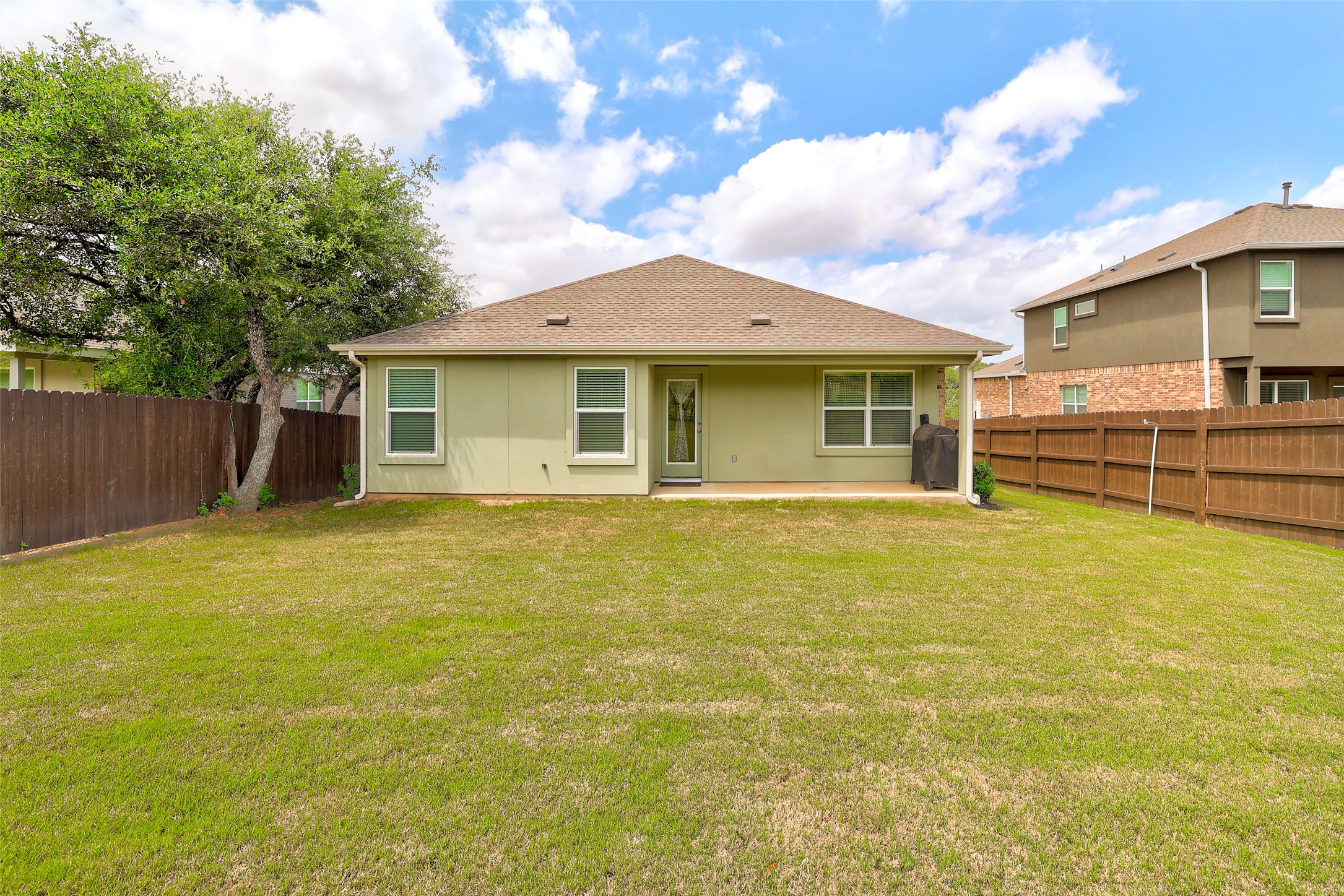 2333 Four Waters Loop Georgetown, TX 78628 - Photo 35 of 35 Expansive green lawn with a privacy fence