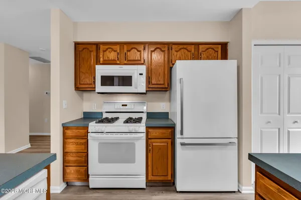 a kitchen with a stove top oven and refrigerator
