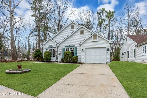 a front view of house with yard and green space