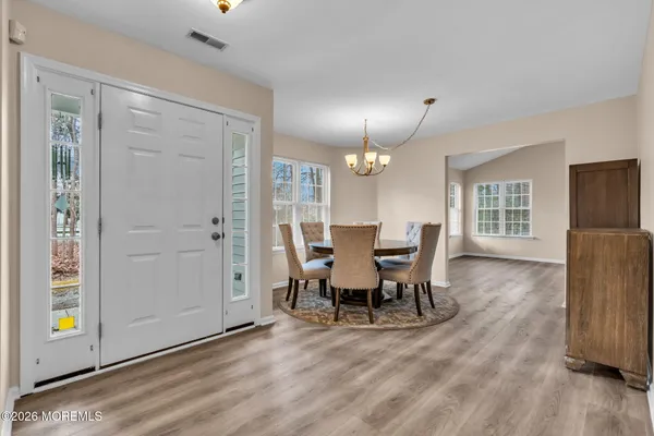a view of a dining room with furniture and wooden floor