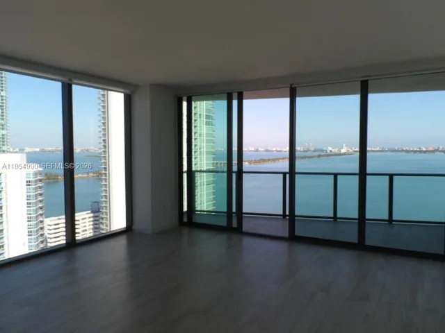 a view of room with large windows