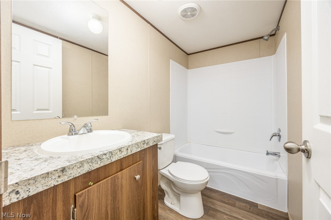 7455 Stanleyville Road Whipple, OH 45788 - Photo 22 of 37 Bathroom featuring a vanity with an oval basin sink, a stone-finish countertop, and wood-finish cabinetry