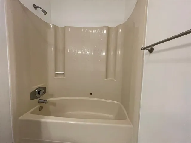 a bathroom with a tub and shower