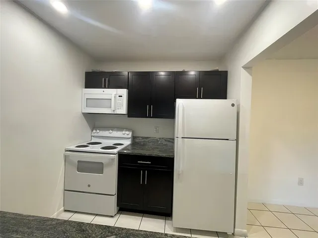 a kitchen with a stove a refrigerator and a sink