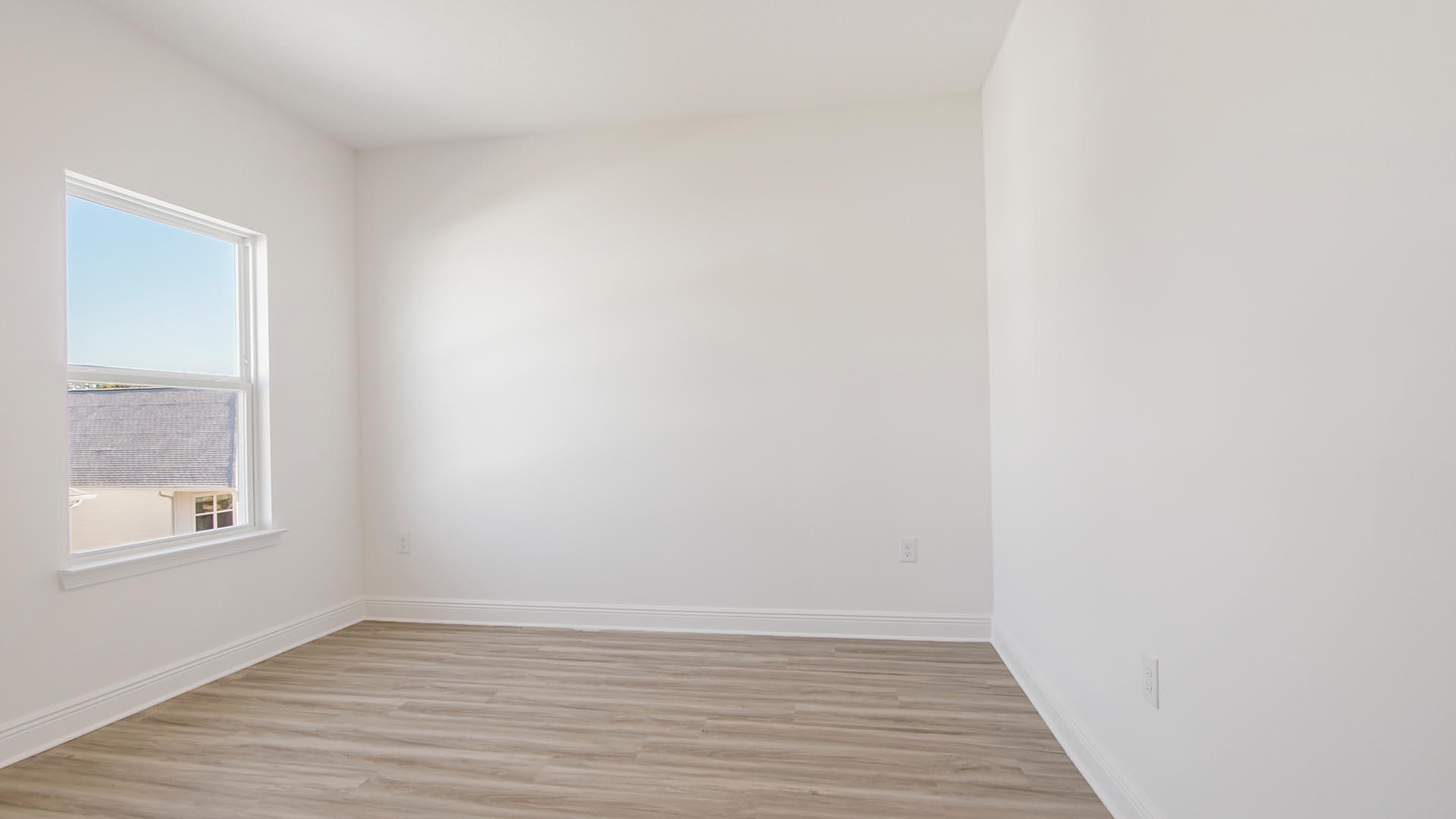 373 Holley Grv Lane Santa Rosa Beach, FL 32459 - Photo 39 of 46 a view of an empty room with wooden floor and a window