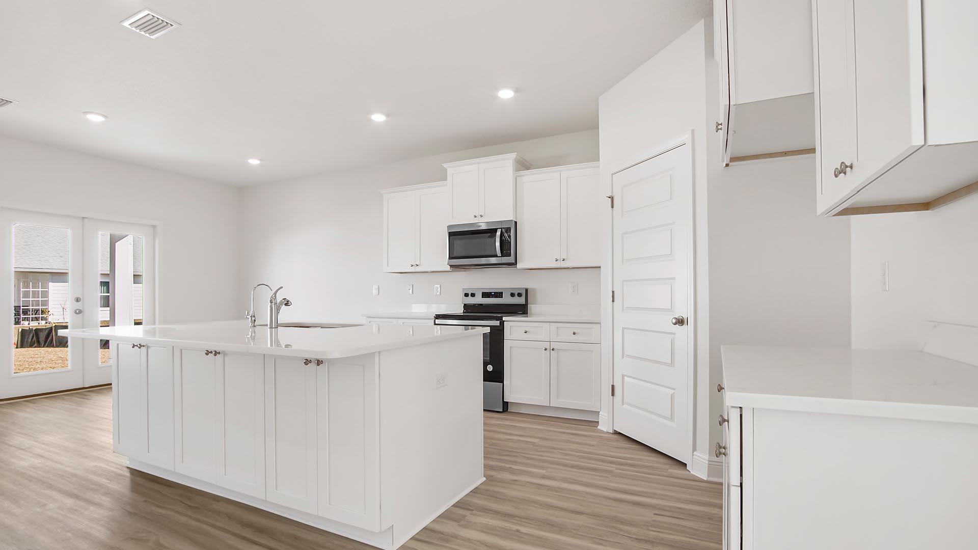 373 Holley Grv Lane Santa Rosa Beach, FL 32459 - Photo 5 of 46 a kitchen with stainless steel appliances a refrigerator stove microwave and cabinets