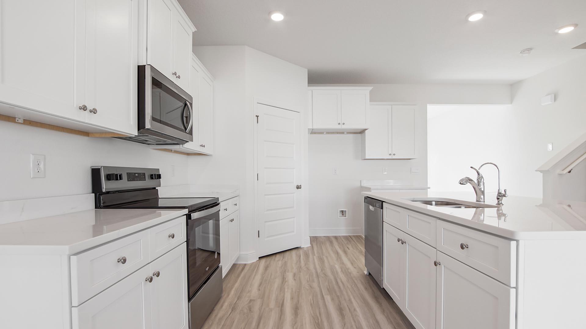 373 Holley Grv Lane Santa Rosa Beach, FL 32459 - Photo 7 of 46 a kitchen with cabinets stainless steel appliances a sink and wooden floor