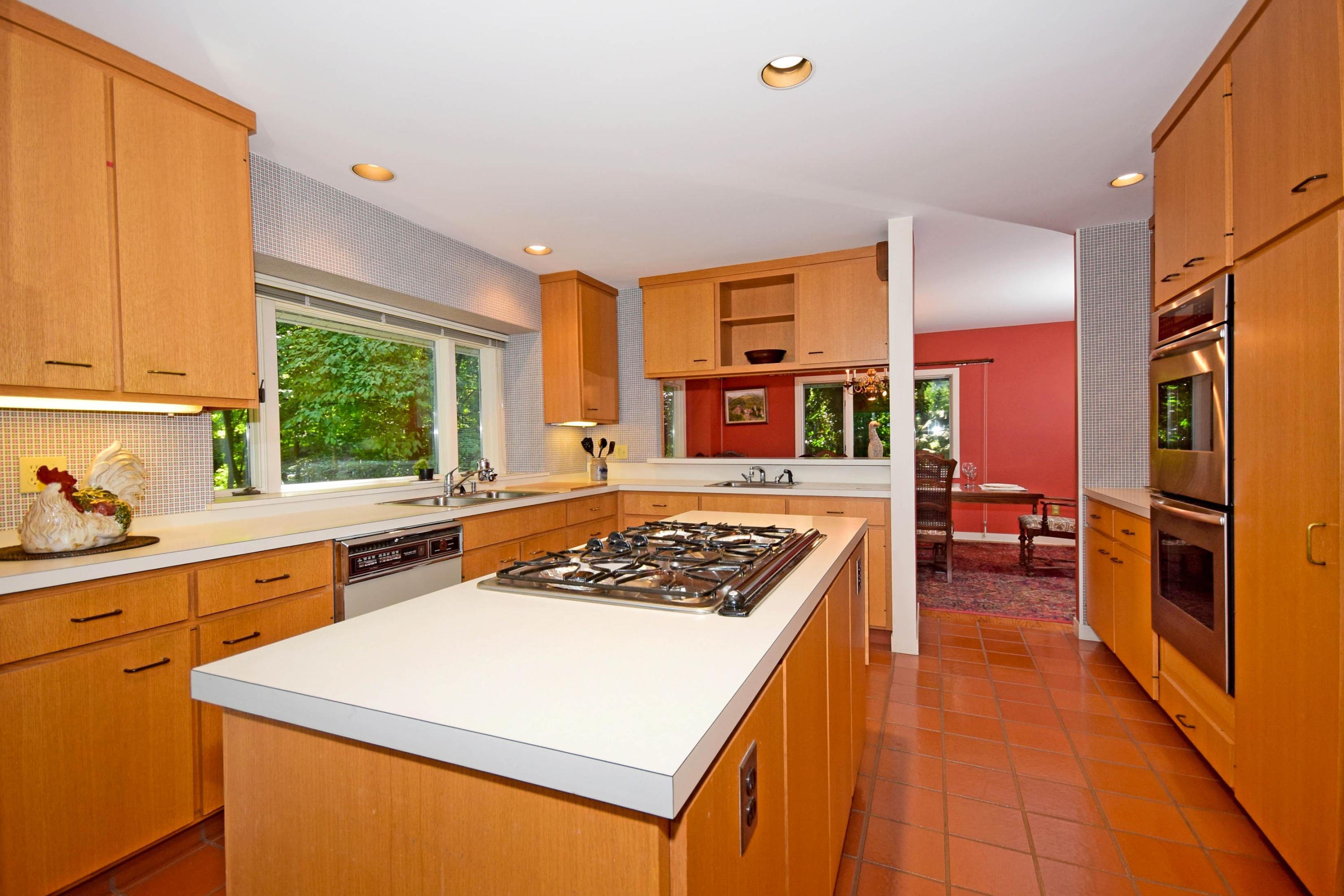 11 Wildcat Road Darien, CT 06820 - Photo 15 of 25 a kitchen with stainless steel appliances granite countertop a stove a sink dishwasher and a refrigerator with wooden floor