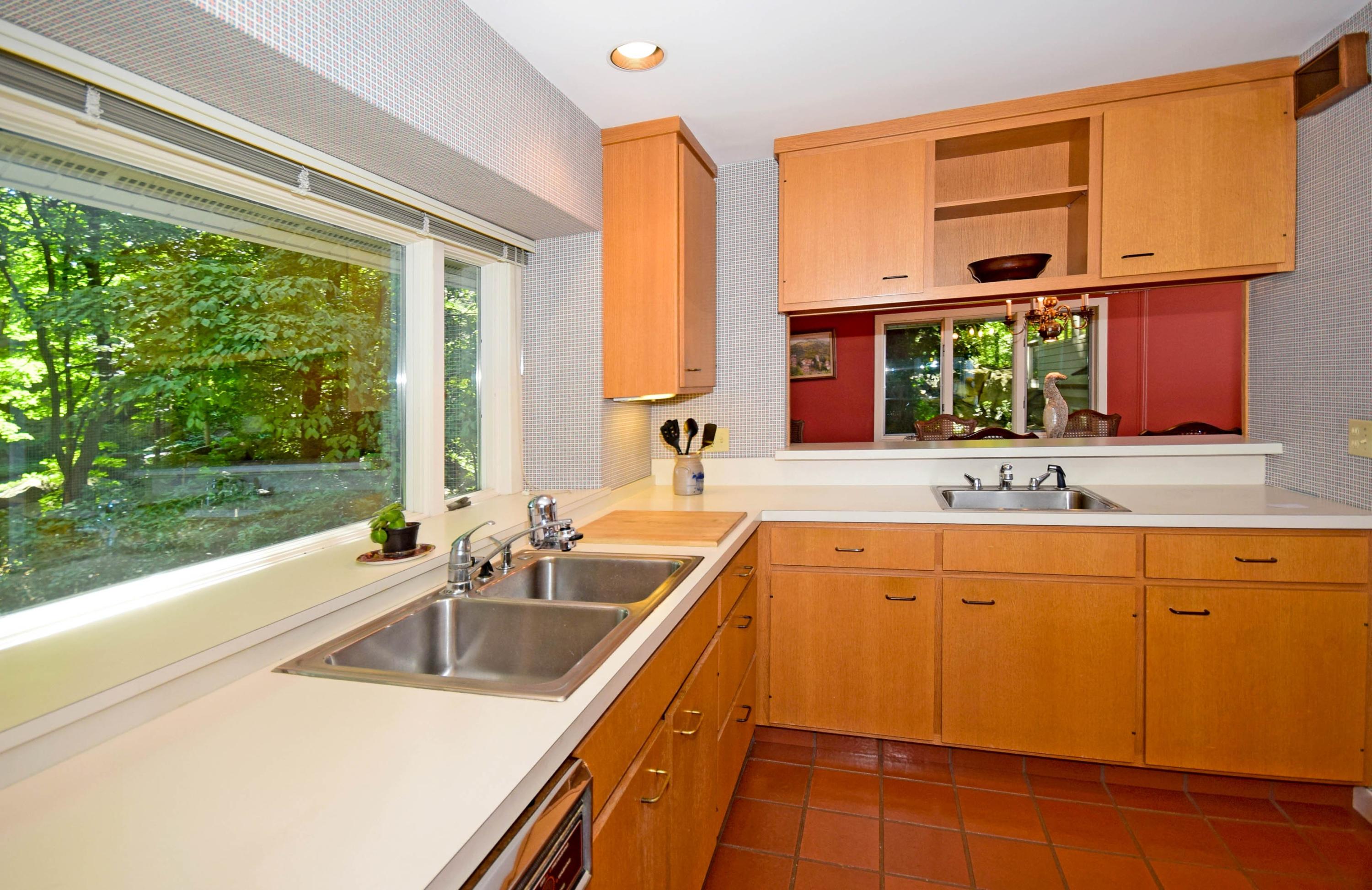 11 Wildcat Road Darien, CT 06820 - Photo 16 of 25 a kitchen with wooden cabinets a sink and a window